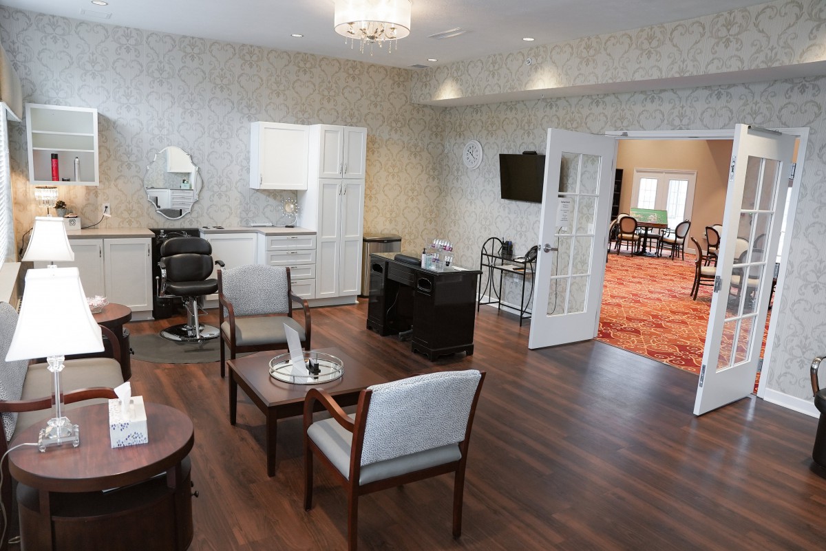 A modern salon interior with seating and styling stations.