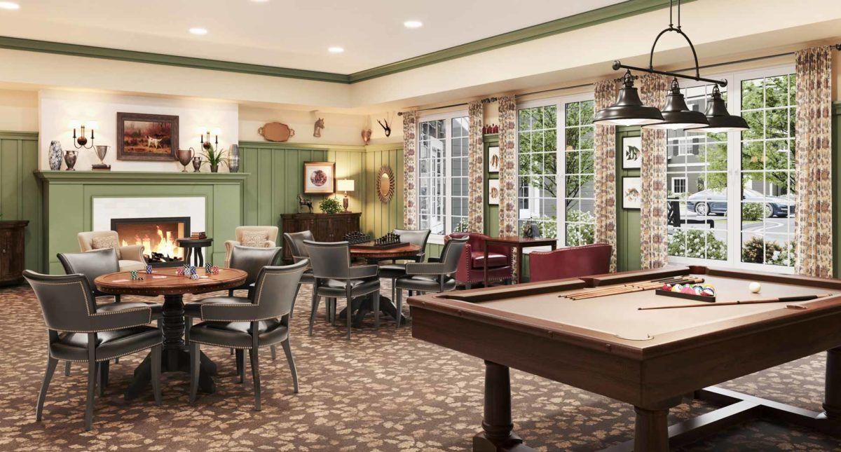 A cozy game room with a pool table, comfortable seating, and large windows providing natural light.