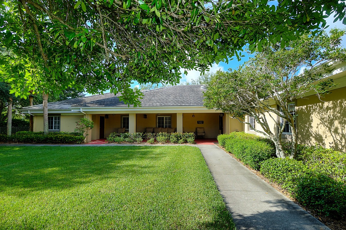 A single-story house with a well-maintained front yard and a pathway leading to the entrance.