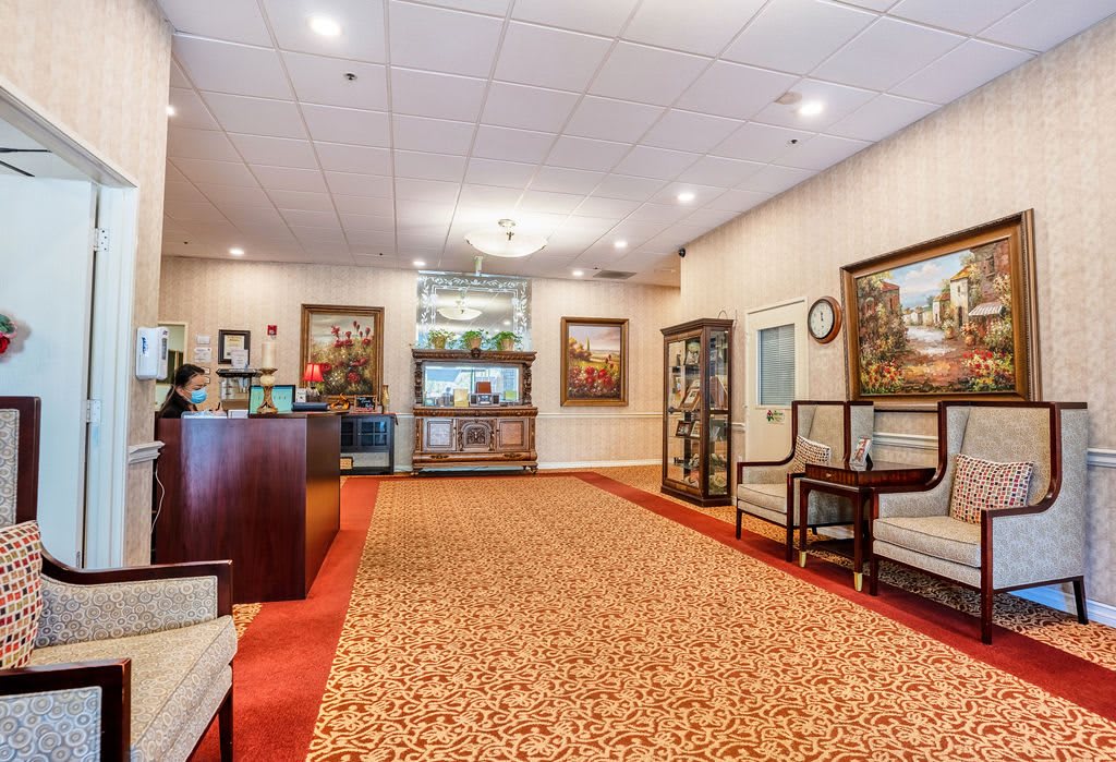 A well-lit lobby with elegant furniture and artwork adorning the walls.