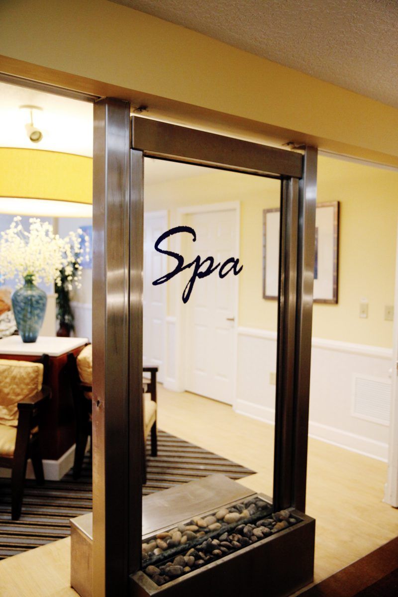A welcoming entrance to a cozy spa, featuring elegant decor and inviting ambiance.