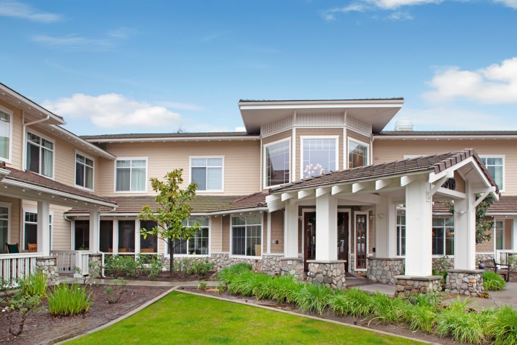 A modern residential house with a landscaped yard and contemporary architectural design.
