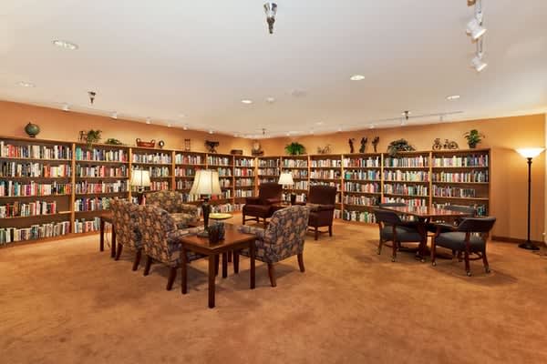 A cozy library with bookshelves and a comfortable seating area.