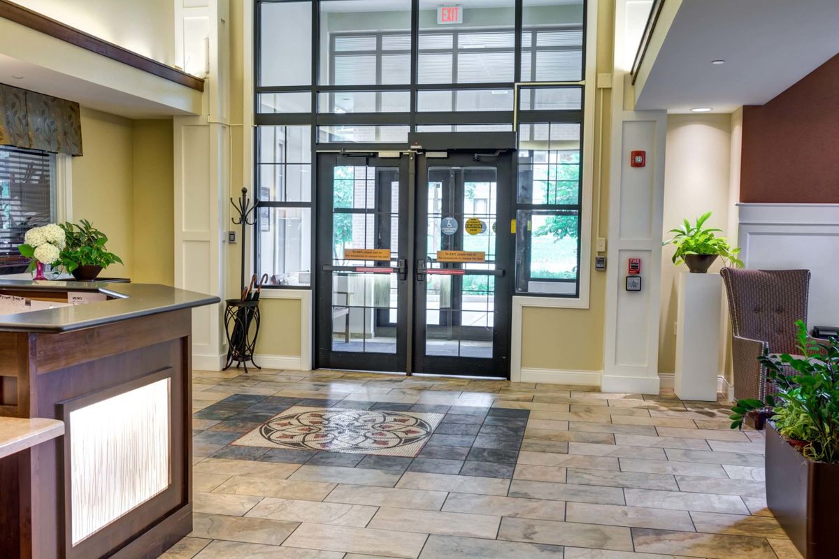 A view of a lobby entrance with decorative tiles and a reception area.