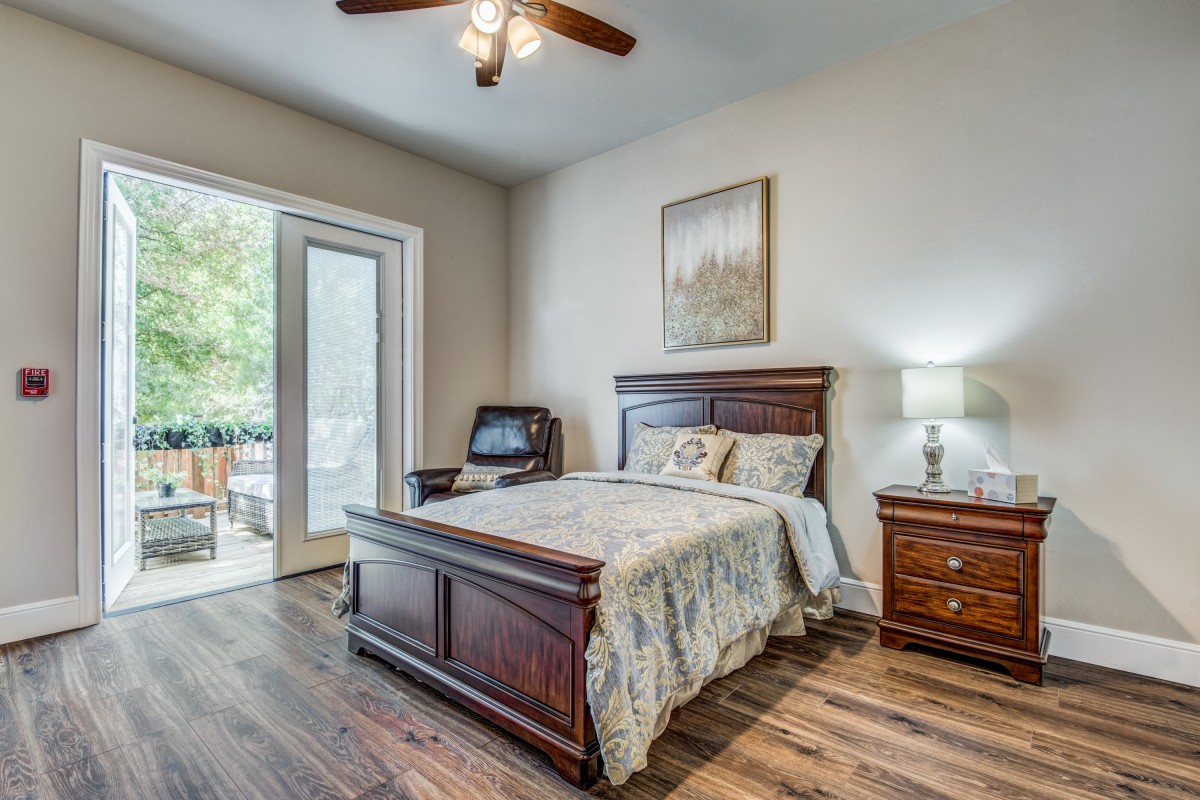 A cozy bedroom with wooden furniture and a ceiling fan.