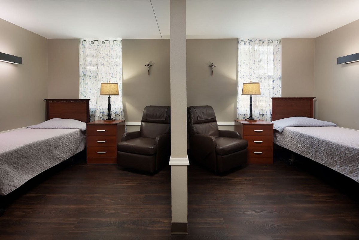 A symmetrical view of a bedroom with matching furniture and decor on either side.