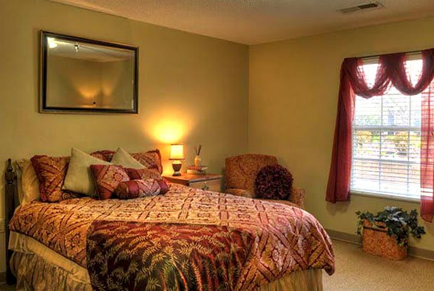 A cozy bedroom with warm lighting and comfortable decor.