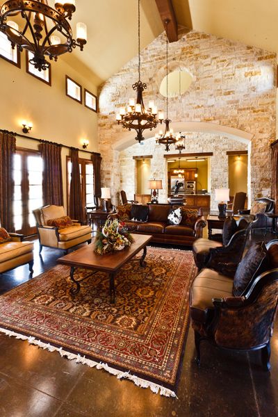 A luxurious living room with elegant furniture and a stone accent wall.