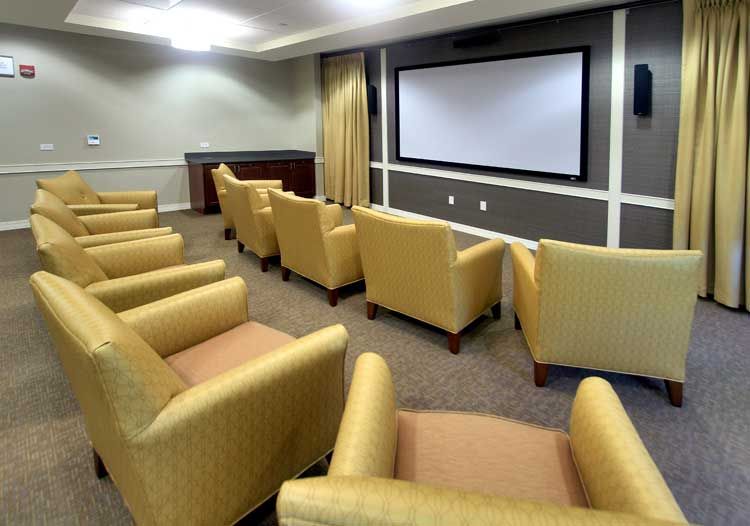 A cozy home theater setup with comfortable seating and a large screen.