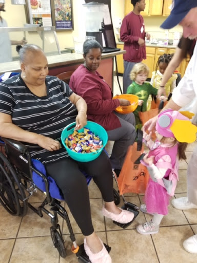 A heartwarming moment of interaction between elderly residents and children during a community activity.