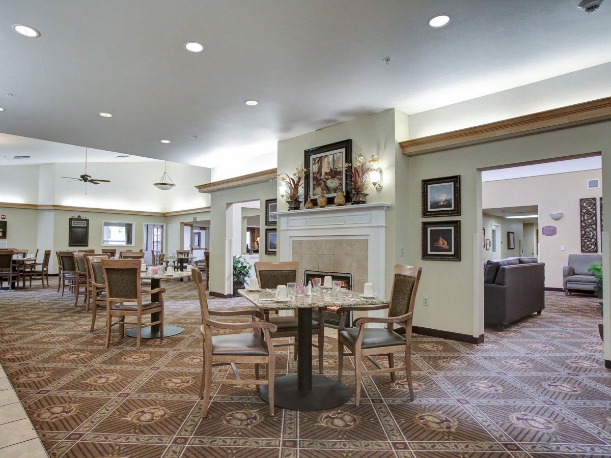 A spacious and elegantly decorated dining area with tables and chairs.