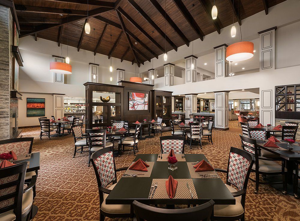 An upscale restaurant dining area with neatly arranged tables and elegant decor.