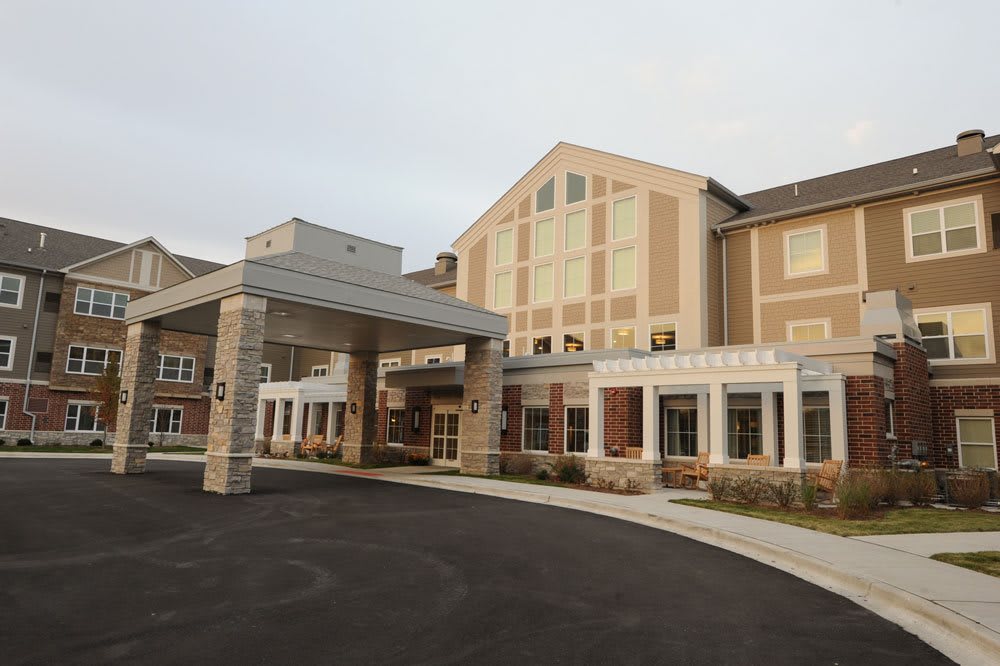 A modern building with a covered entrance and large windows.