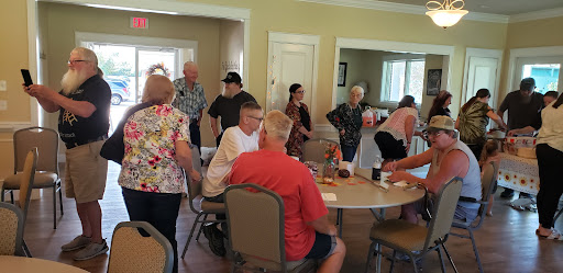 A lively community gathering with people engaged in conversation and activities.