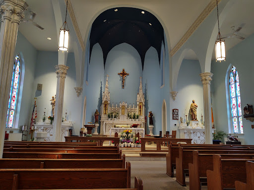 A serene view of the interior of a church, showcasing the altar and wooden pews.