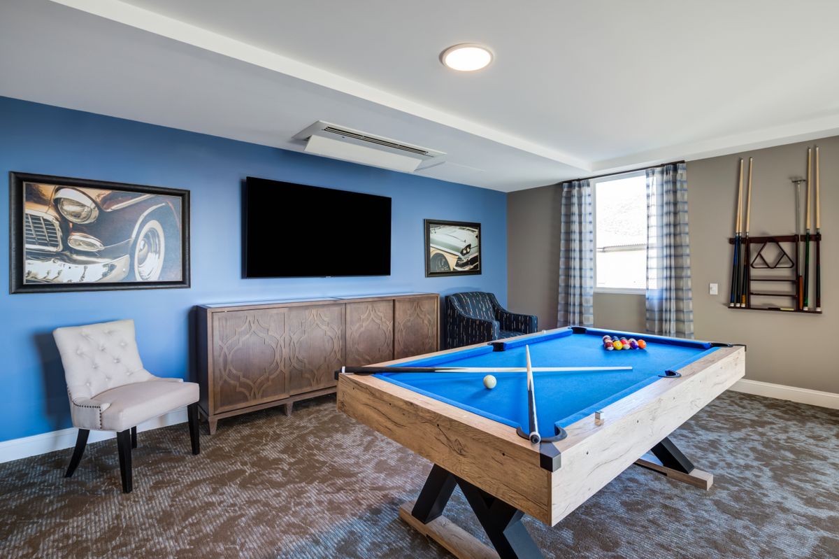 Modern game room featuring a pool table and wall-mounted television.