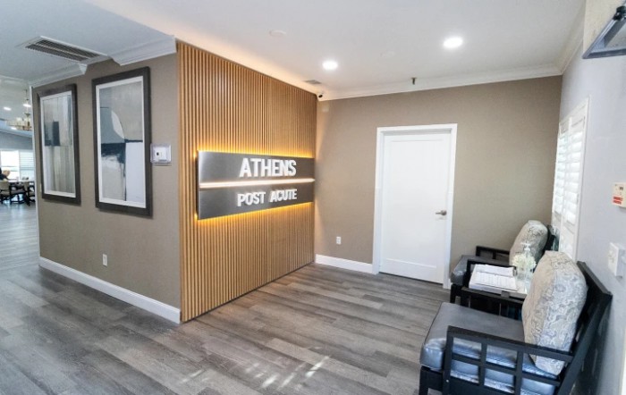Modern waiting area in a clinic with wood paneling and signage.