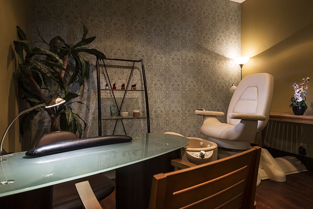 A tranquil spa room with a massage chair and soothing decor.