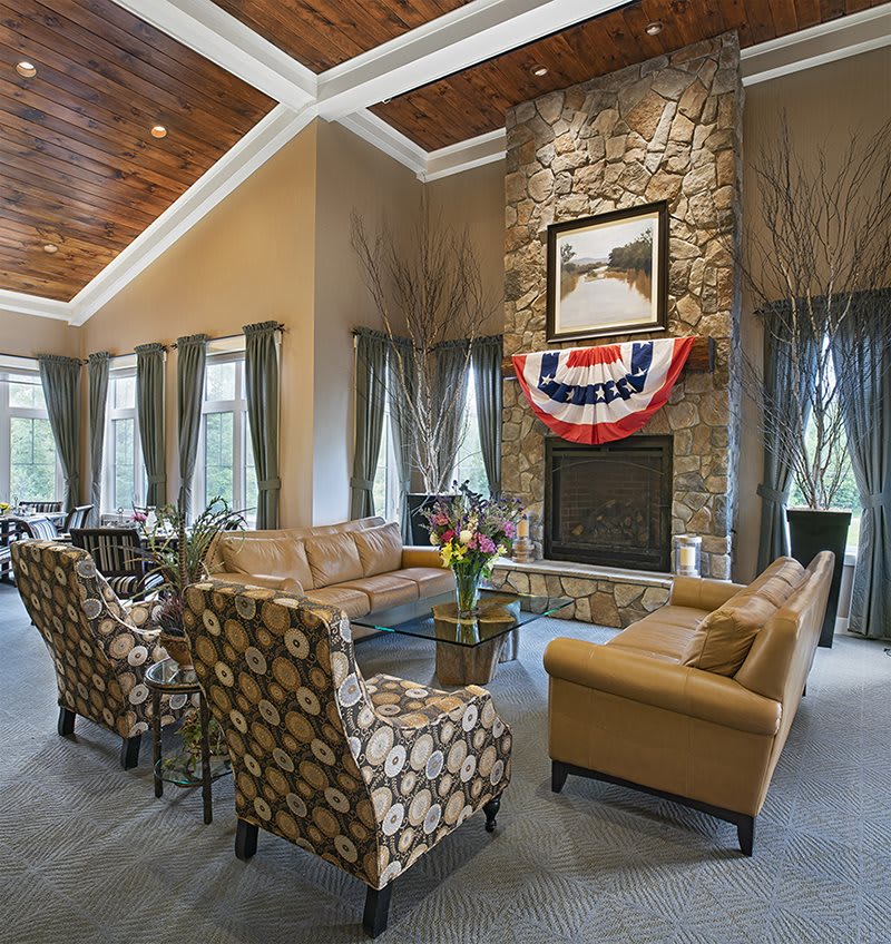 A cozy living room featuring a stone fireplace and comfortable seating.