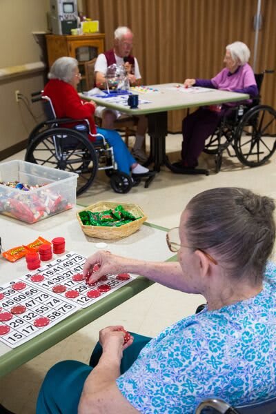 Residents engage in a bingo activity at a nursing home.