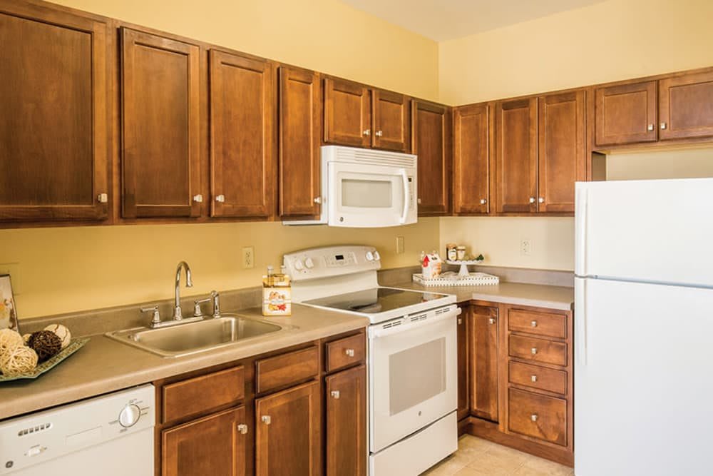 A cozy kitchen with wooden cabinets and modern appliances.