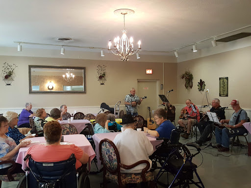 A lively music performance at a community center, where senior citizens enjoy an engaging social gathering.