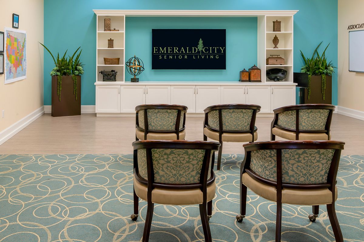 A neatly arranged meeting room with chairs facing a television.