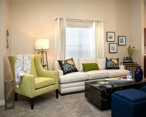A cozy and modern living room featuring a stylish sofa, vibrant armchair, and attractive decor.
