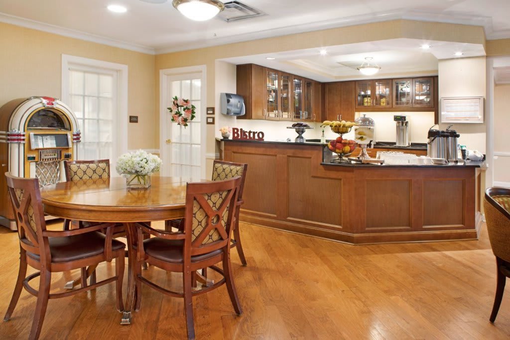An open concept kitchen and dining area with wooden furniture and warm lighting.