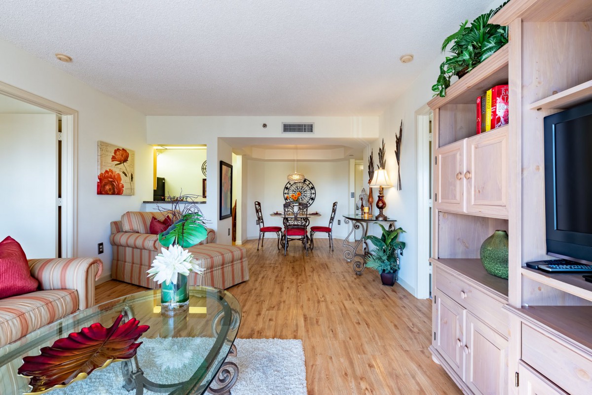 Spacious living room with wooden flooring and a stylish dining area.