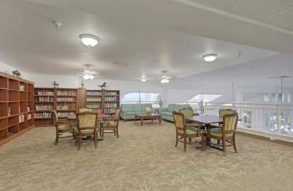 A quiet reading area with bookshelves, tables, and chairs.