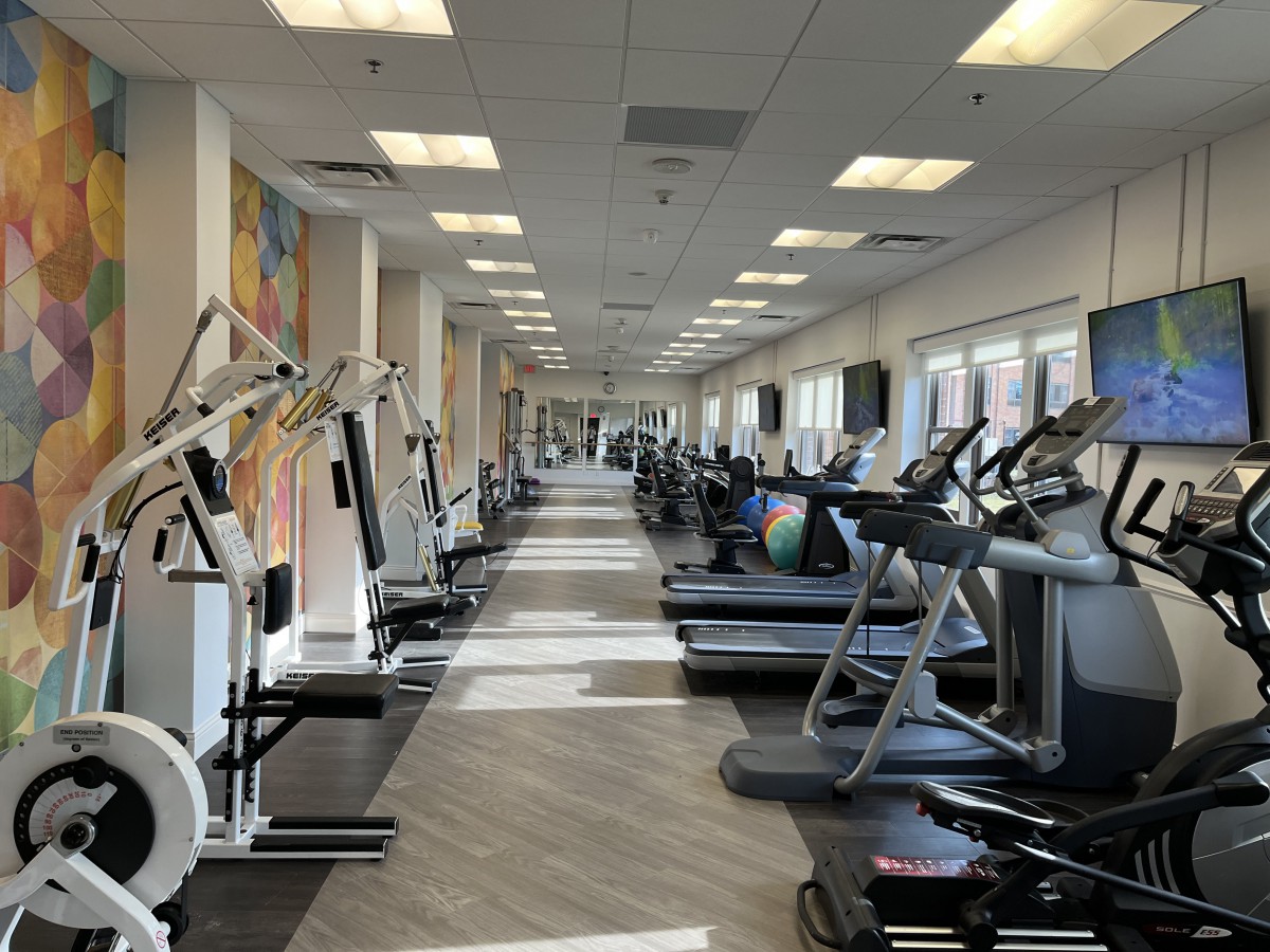 A spacious gym equipped with various exercise machines and treadmills.