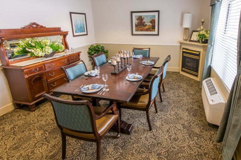 A well-decorated dining room with a set table and elegant furnishings.