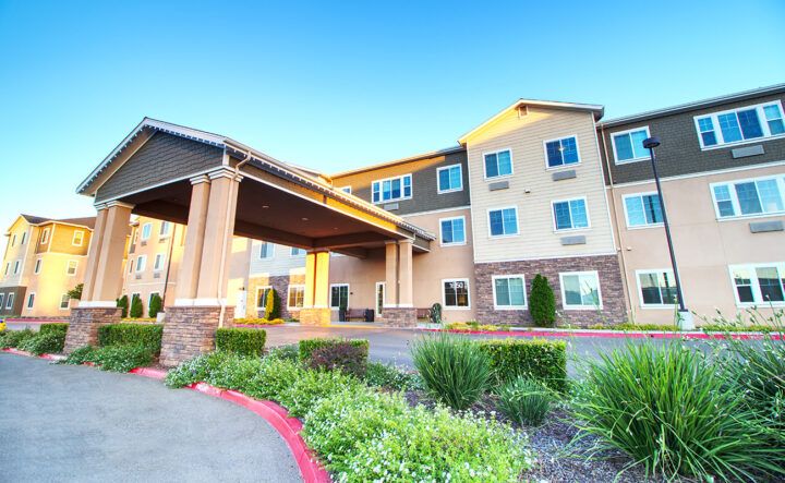 A modern hotel building with a welcoming entrance and landscaped surroundings.