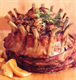 A beautifully presented crown roast garnished with herbs.