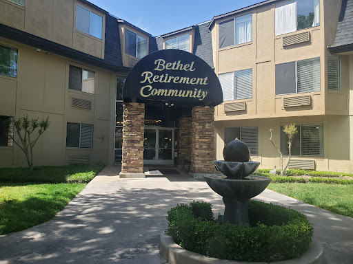 Entrance of Bethel Retirement Community featuring a welcoming fountain and landscaped area.
