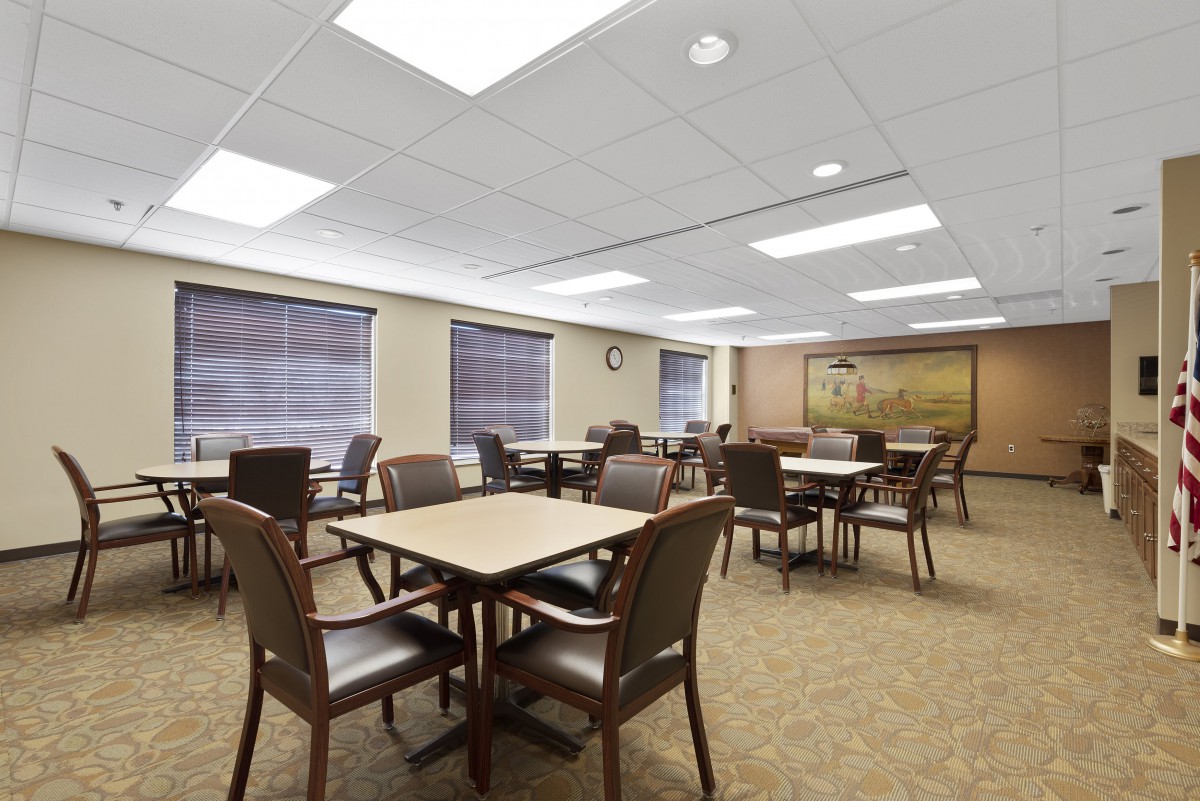 A modern conference room with tables and chairs arranged for meetings.