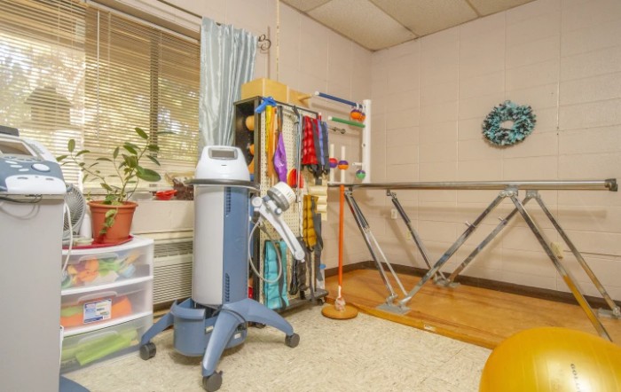 A well-equipped physical therapy room with various rehabilitation tools and exercise equipment.