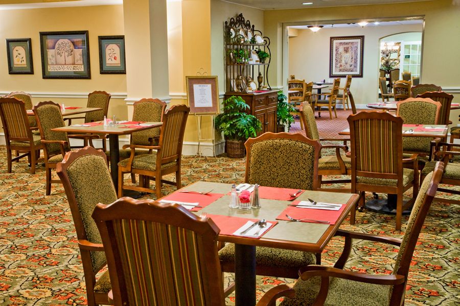 An elegant dining room setup with neatly arranged tables and chairs, perfect for a fine dining experience.