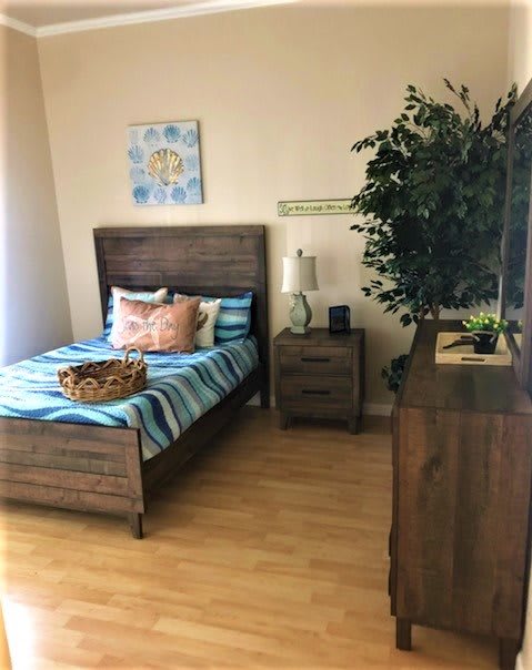 A cozy bedroom with wooden furniture and vibrant decor.