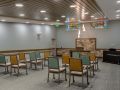 An empty conference room with chairs arranged in rows and colorful decorations hanging from the ceiling.