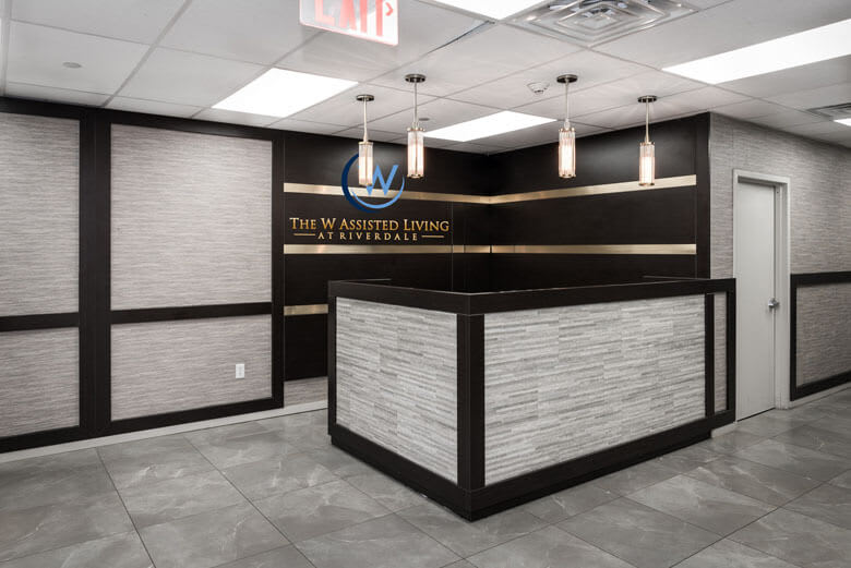 Modern office reception area with a sleek desk and elegant lighting.