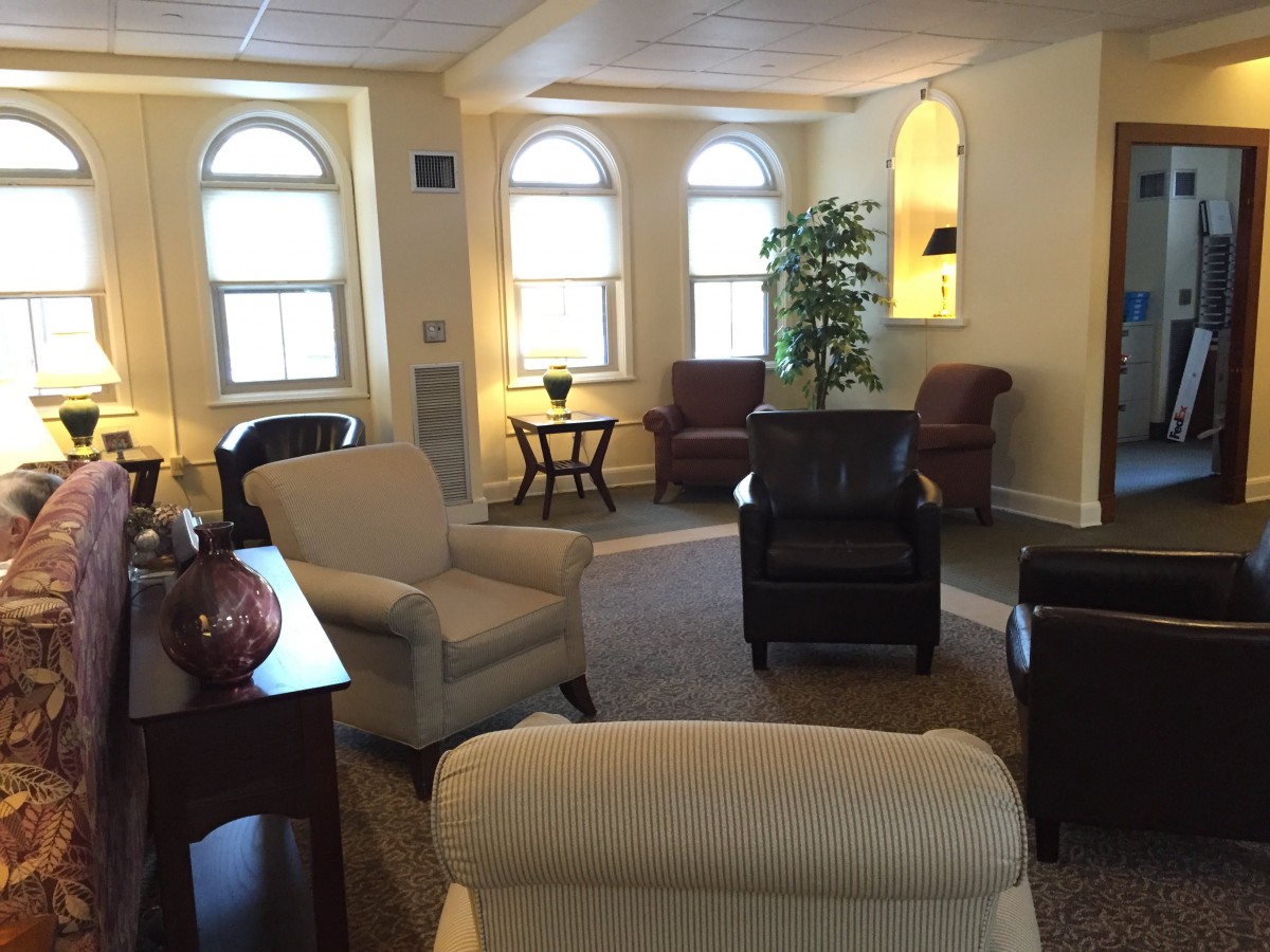 A cozy living room with comfortable seating and large windows.