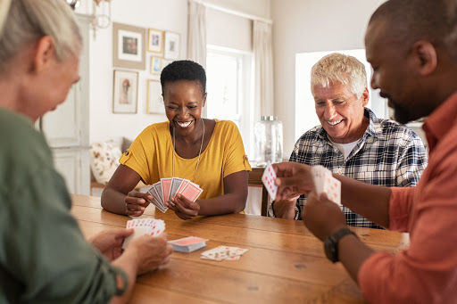 Friends enjoying a lively card game together.