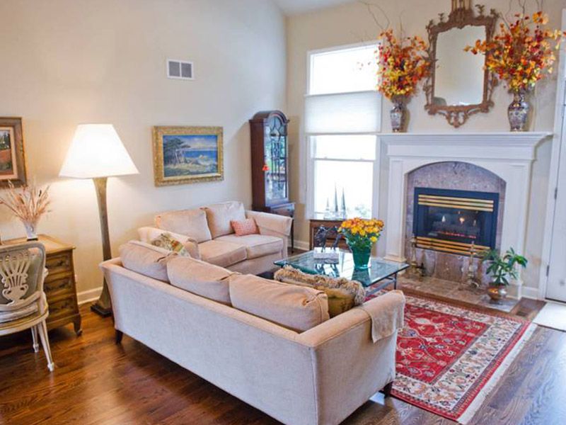 A cozy living room featuring a sofa, fireplace, and elegant decor.