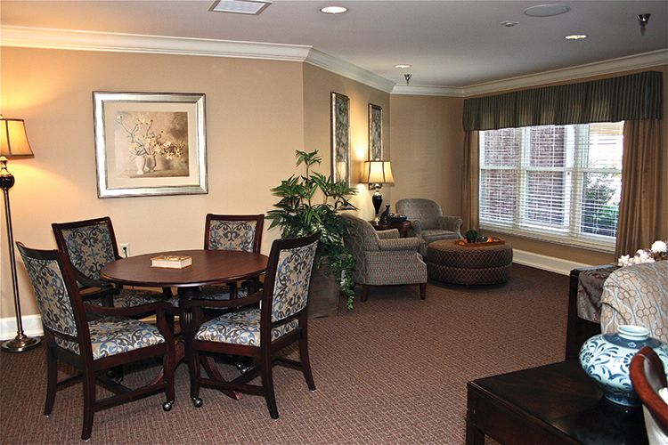 A cozy living room with a dining table and comfortable seating area.