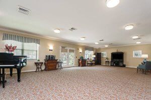 A spacious living room with carpet and furniture.