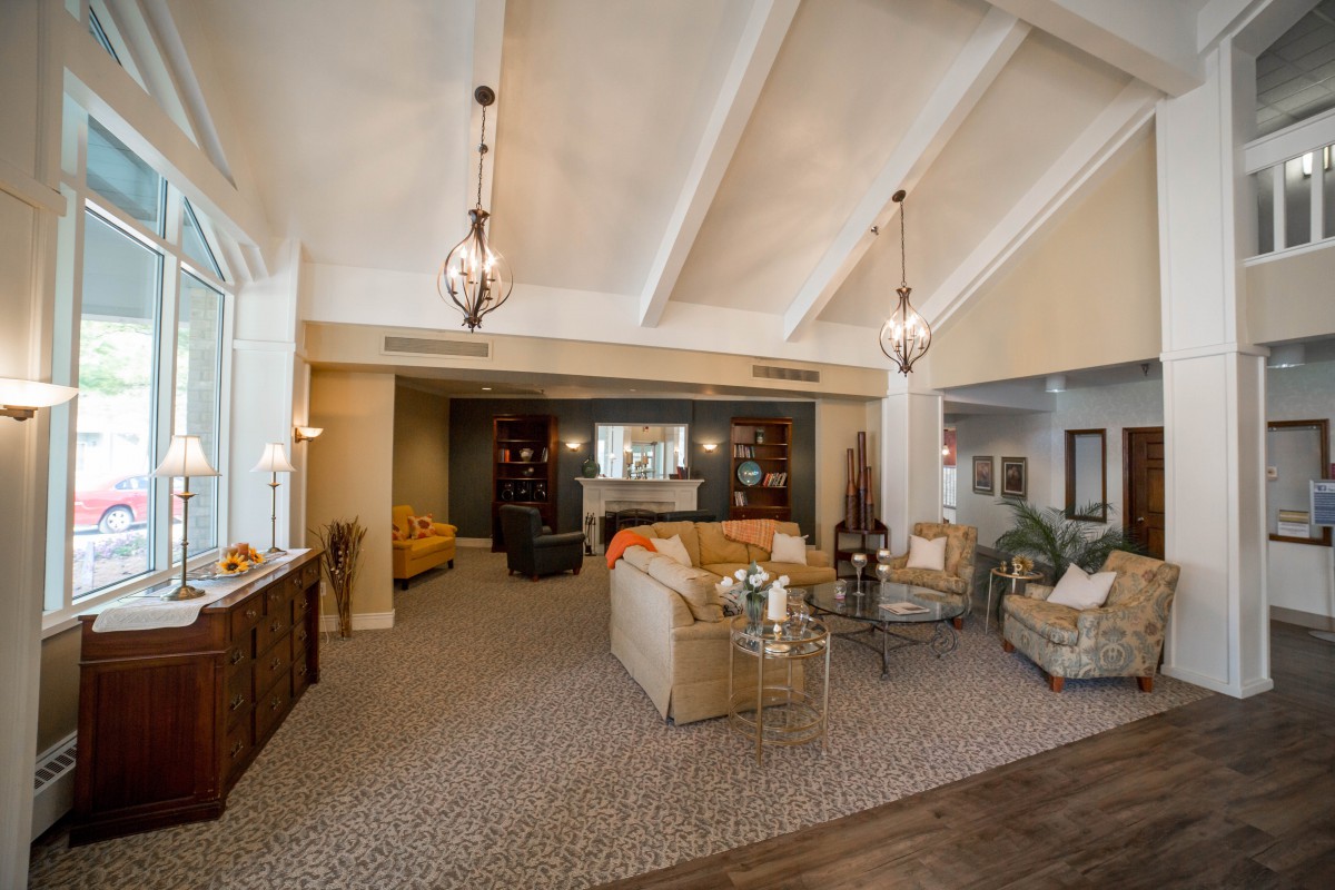 Spacious living area with vaulted ceilings and elegant pendant lighting.