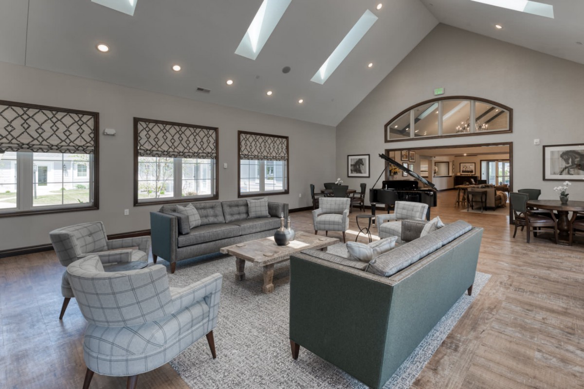 A spacious and modern living room with comfortable seating and ample natural light.