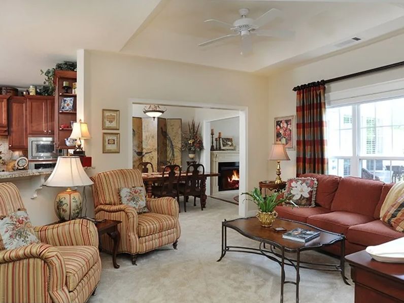 A cozy living room with comfortable seating and a warm fireplace.